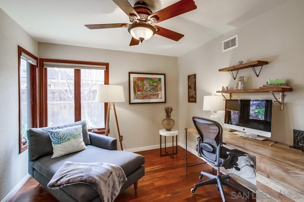 12128 Eagle Street San Diego, CA 92131 - Photo 19 of 37 a bedroom with a bed wooden floor and a ceiling fan