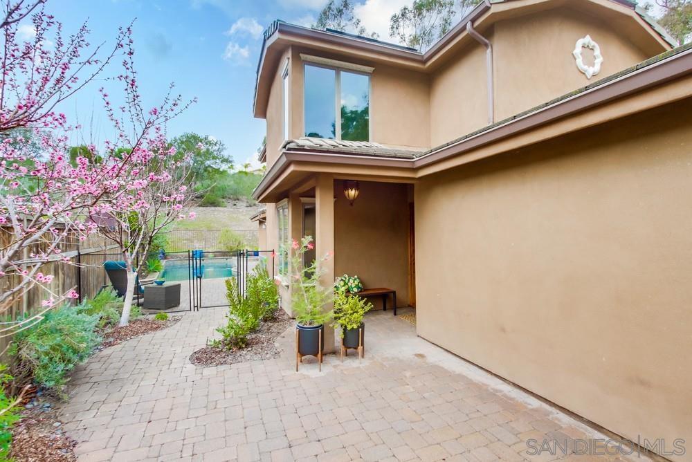 12128 Eagle Street San Diego, CA 92131 - Photo 2 of 37 a view of a house with a small yard plants and a large tree