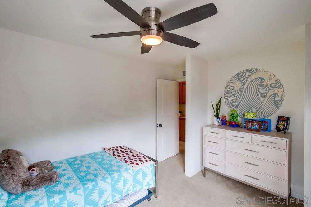 12128 Eagle Street San Diego, CA 92131 - Photo 27 of 37 a bedroom with a bed and a dresser in it