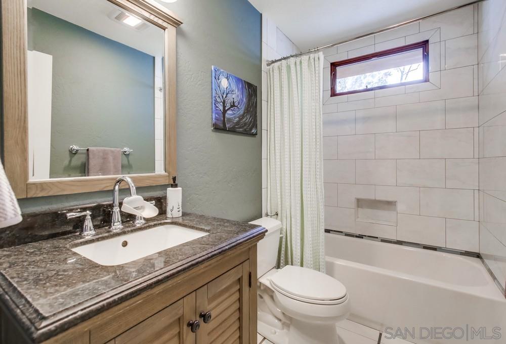 12128 Eagle Street San Diego, CA 92131 - Photo 29 of 37 a bathroom with a granite countertop sink toilet and shower