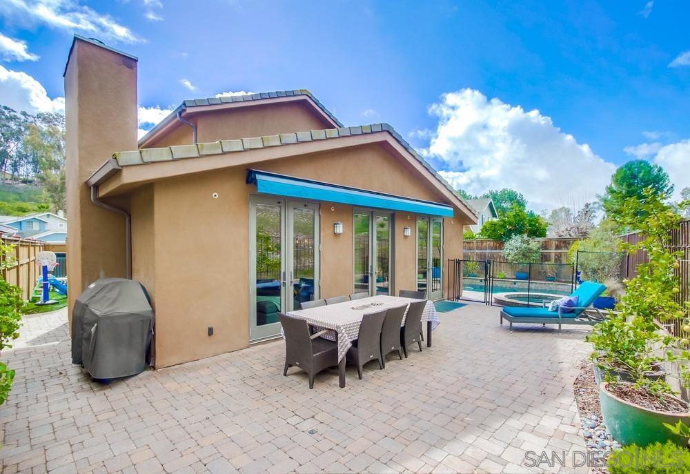 12128 Eagle Street San Diego, CA 92131 - Photo 30 of 37 a patio table and chairs with potted plants