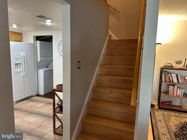 a kitchen with a refrigerator a stove top oven a sink and dishwasher