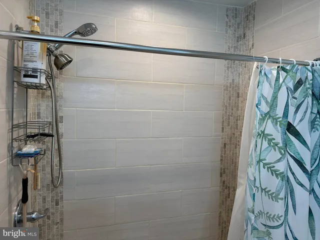 a bathroom with a sink a mirror and a shower