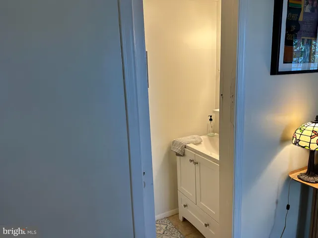 a living room with furniture and a lamp