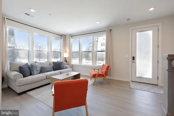 a living room with furniture and large windows