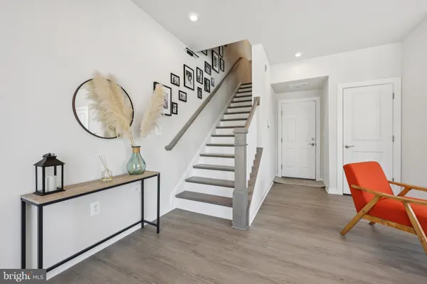 a view of an entryway with wooden floor