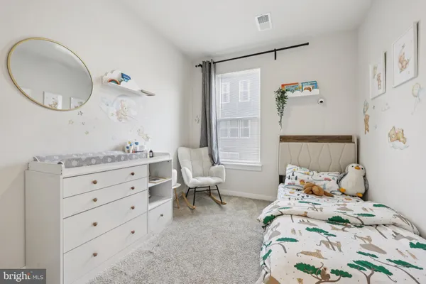 a bedroom with a bed and a mirror