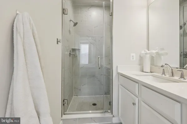 a bathroom with a shower and a sink