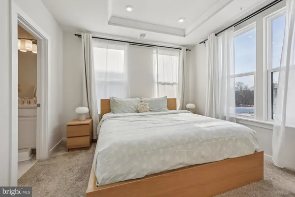 a bedroom with a large bed and a large window