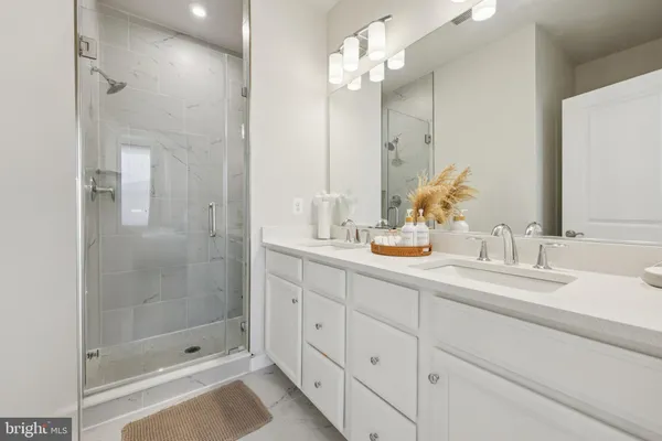 a bathroom with double sink and a mirror