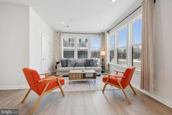 a living room with furniture and a floor to ceiling window