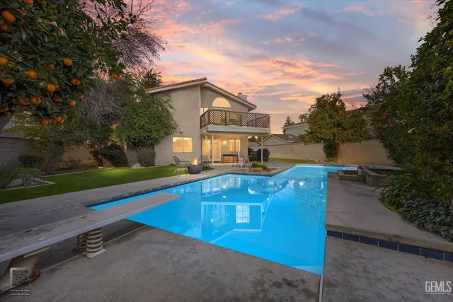 an aerial view of a house with a yard basket ball court and outdoor seating