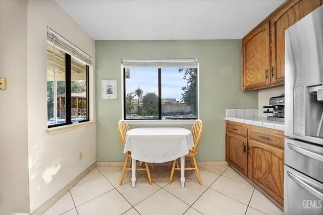 a bedroom with a bed window and chair