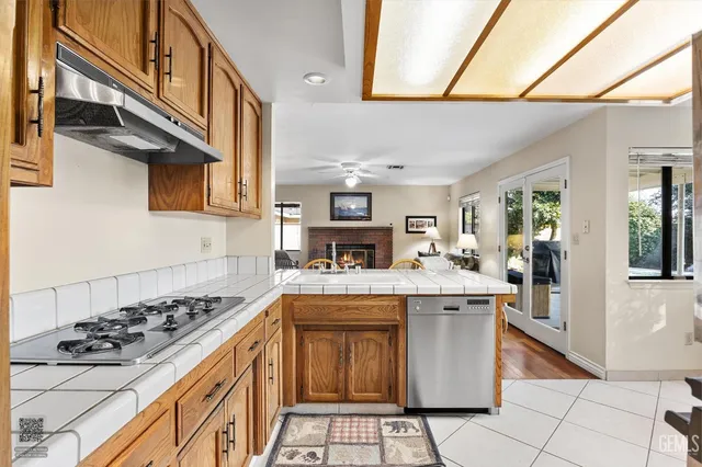 a view of a hallway to a livingroom with wooden furniture