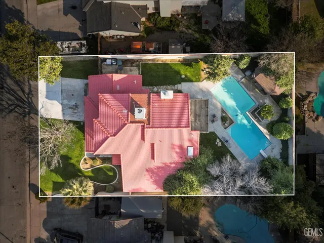 an aerial view of residential houses with city view