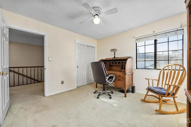 a view of a white house with a swimming pool and a yard