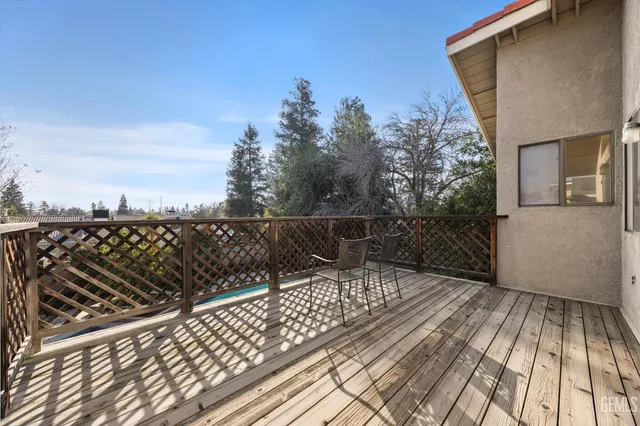 an aerial view of a house with a yard and a large tree