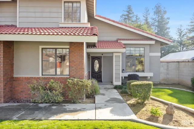 a living room with fireplace furniture and a wooden floor