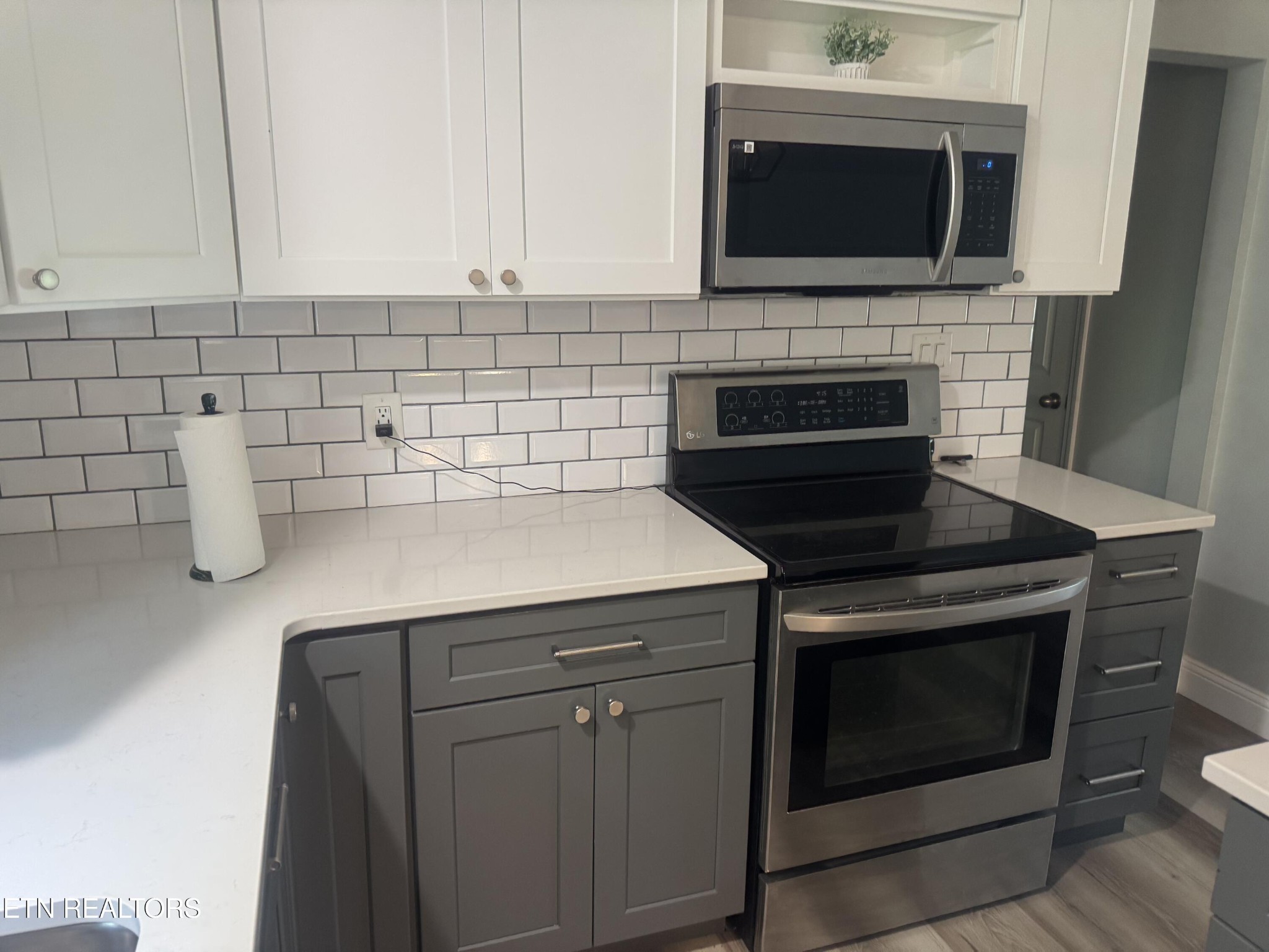 3341 West Wolf Valley Road Clinton, TN 37716 - Photo 11 of 41 a kitchen with a stove and a microwave