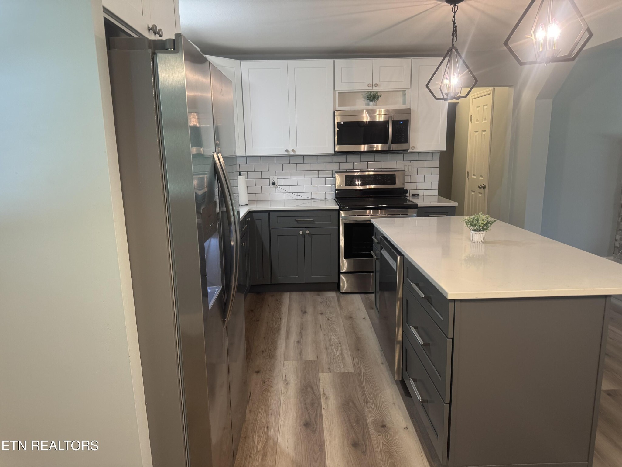 3341 West Wolf Valley Road Clinton, TN 37716 - Photo 14 of 41 a kitchen with stainless steel appliances a stove refrigerator sink and microwave
