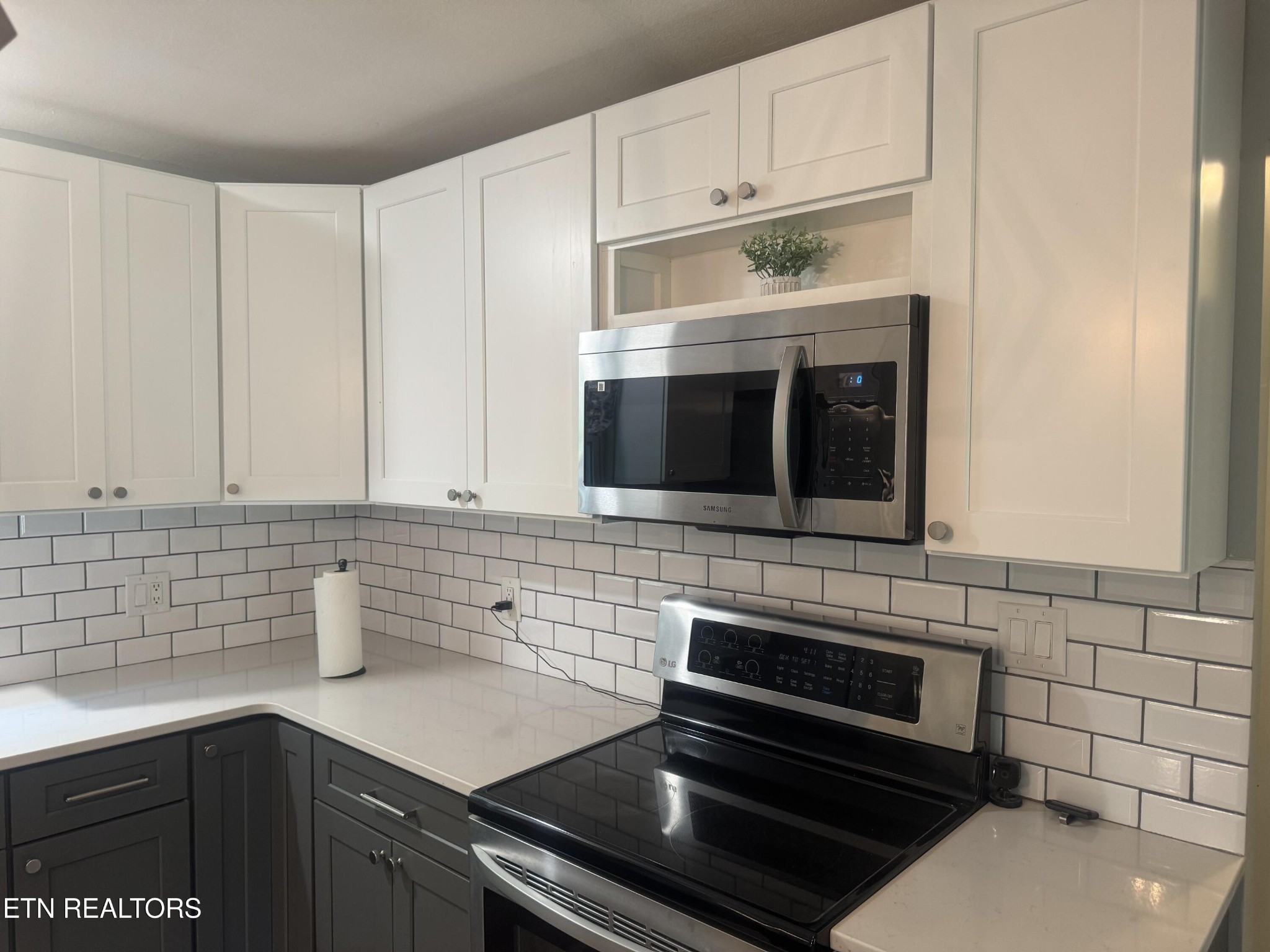3341 West Wolf Valley Road Clinton, TN 37716 - Photo 15 of 41 a kitchen with stainless steel appliances a stove microwave and sink