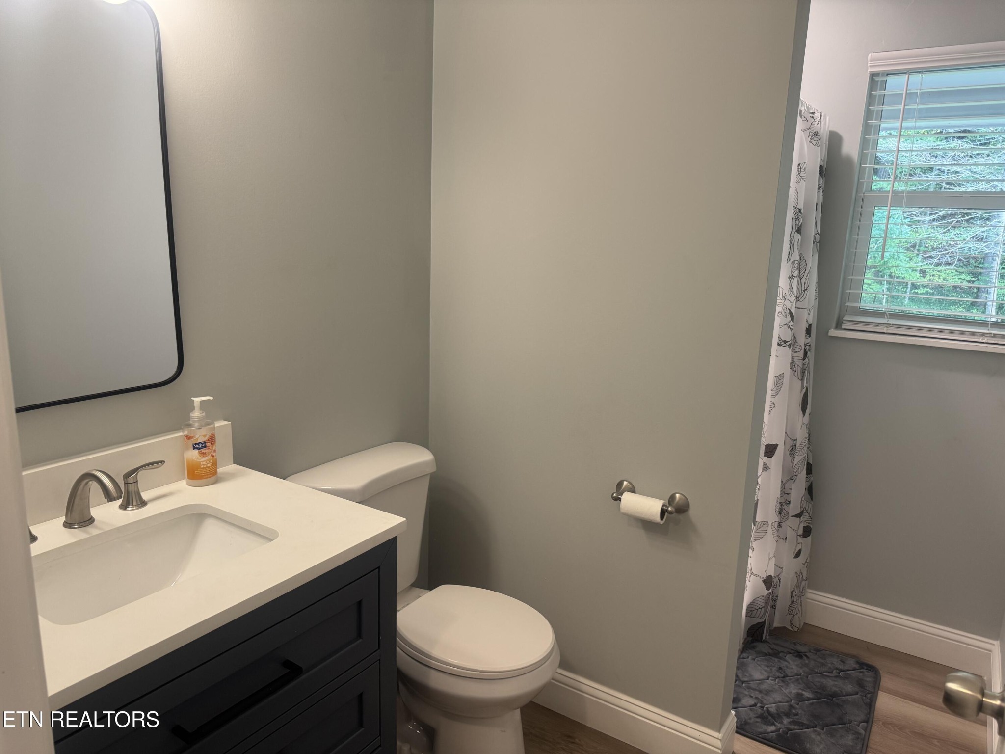 3341 West Wolf Valley Road Clinton, TN 37716 - Photo 17 of 41 a bathroom with a sink toilet and a mirror