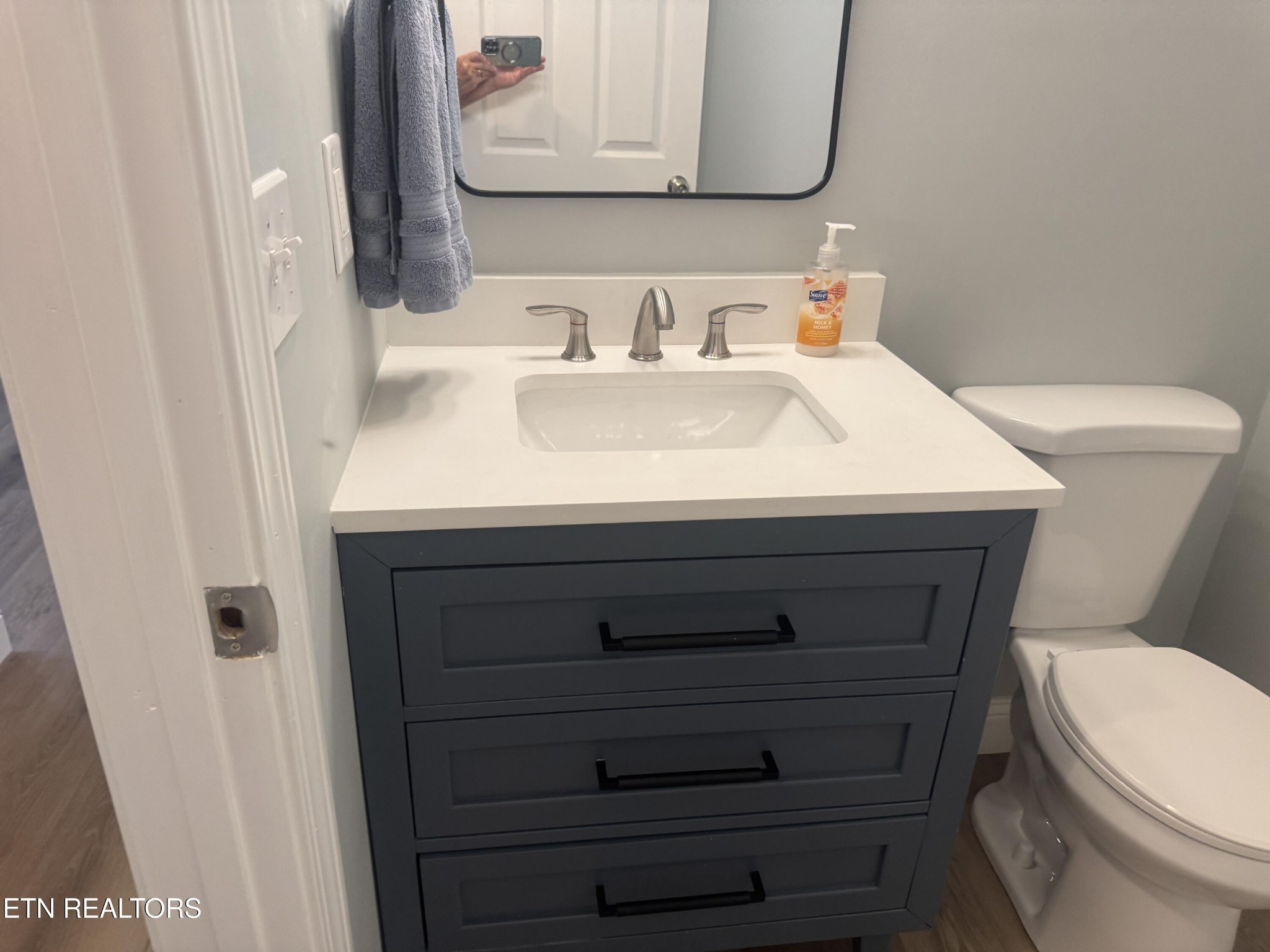 3341 West Wolf Valley Road Clinton, TN 37716 - Photo 18 of 41 a bathroom with a sink a toilet and mirror