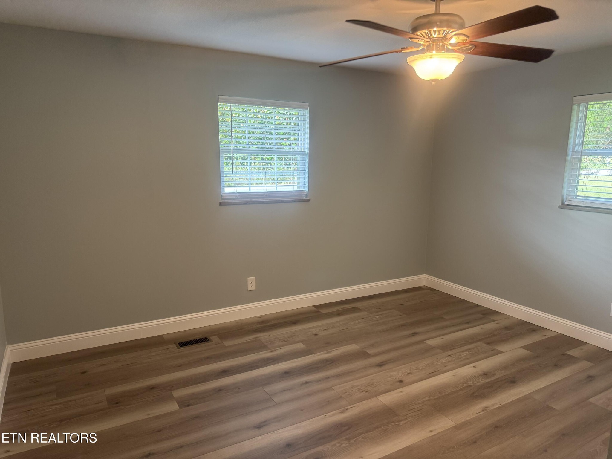 3341 West Wolf Valley Road Clinton, TN 37716 - Photo 32 of 41 wooden floor in an empty room with a window