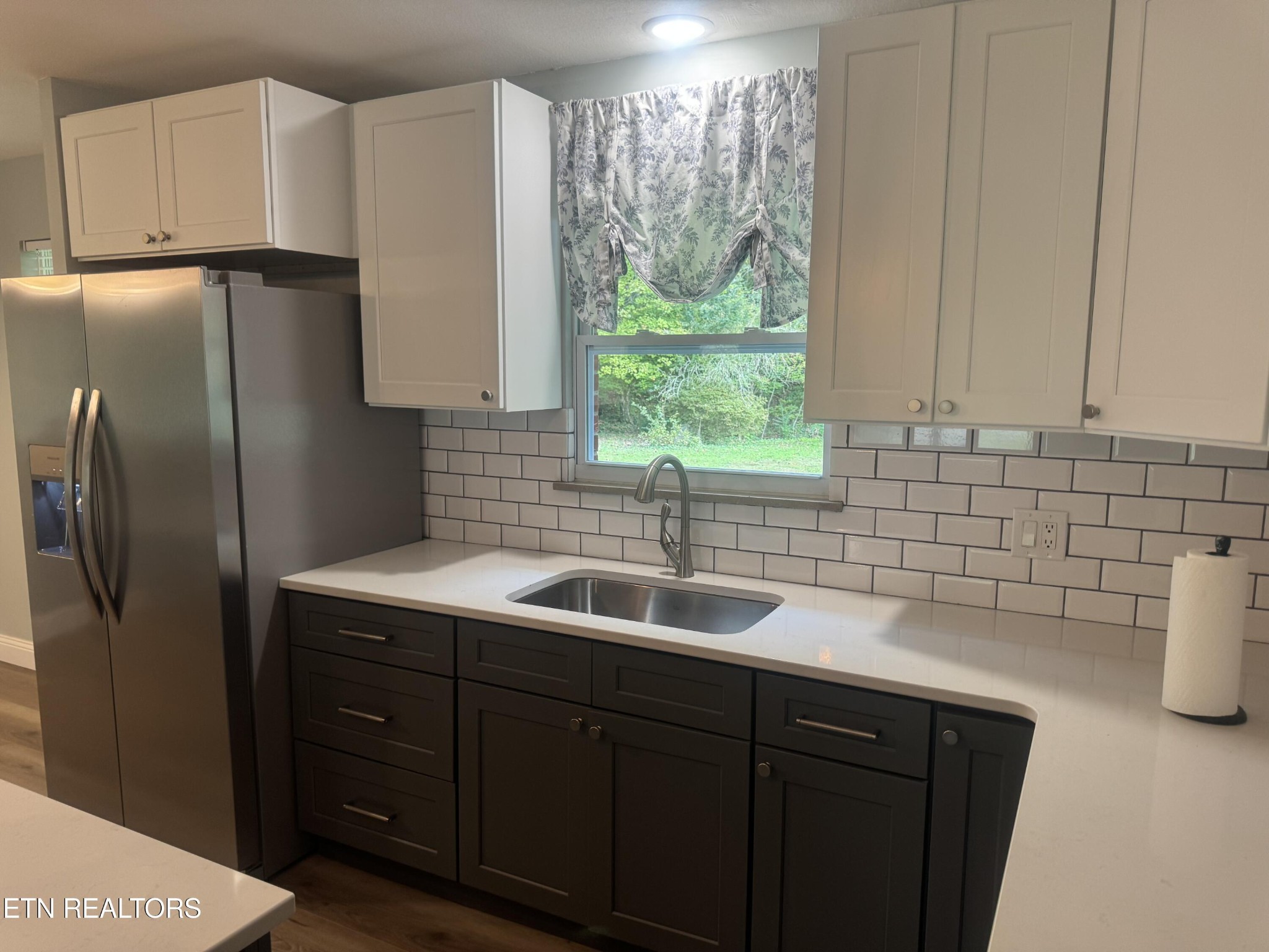 3341 West Wolf Valley Road Clinton, TN 37716 - Photo 9 of 41 a kitchen with a sink and cabinets