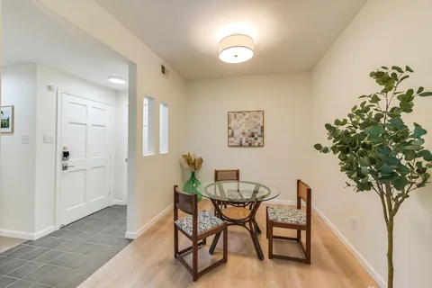 a view of a livingroom with furniture and a potted plant