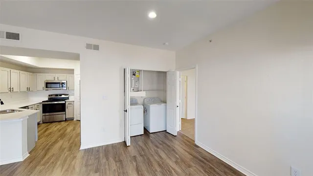 a view of a livingroom with a ceiling fan and wooden floor