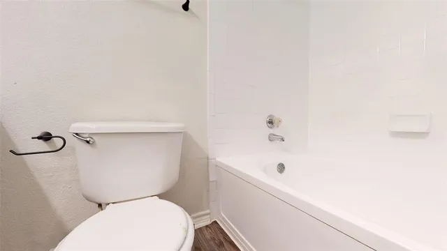 an empty room with closet and a ceiling fan