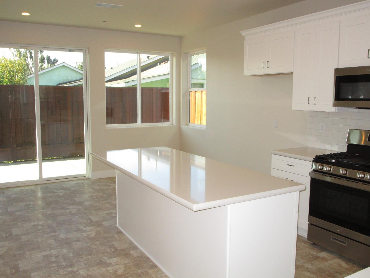 159 Terrace Drive Greenfield, CA 93927 - Photo 4 of 23 a kitchen with stainless steel appliances granite countertop a stove a sink and a microwave