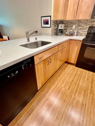 a kitchen with stainless steel appliances granite countertop a sink stove and cabinets
