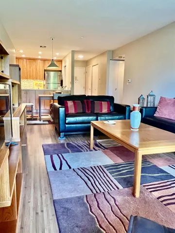 a living room with lots of furniture and wooden floor