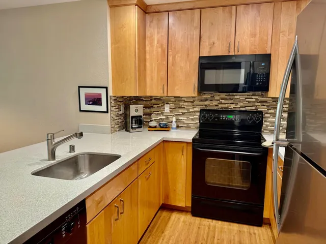 a kitchen with a sink stove and microwave