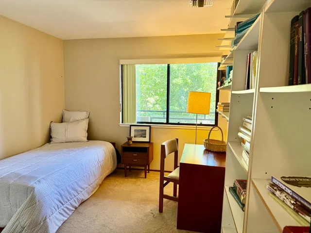 a bedroom with a bed and a window