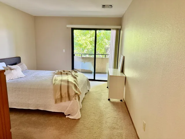 a bedroom with bed and window