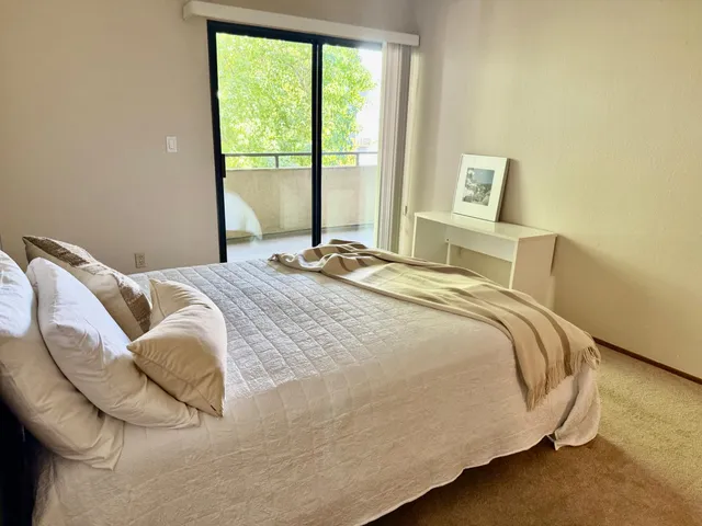 a bedroom with a bed and window