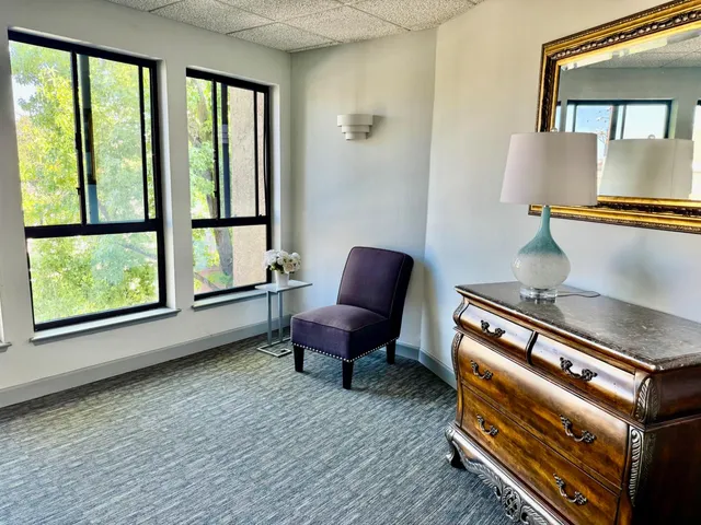 a room with a chair and a dresser