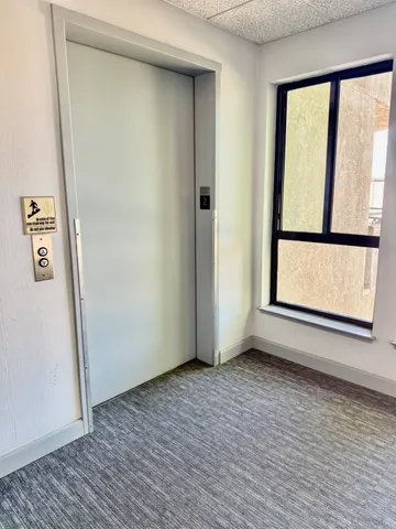 a view of a house with a wooden fence