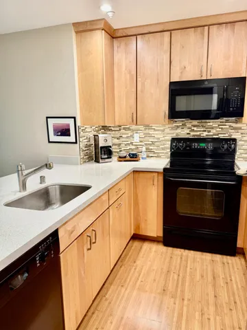 a kitchen with a sink stove and microwave