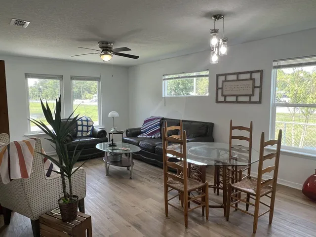 a view of a dining room with furniture window and wooden floor