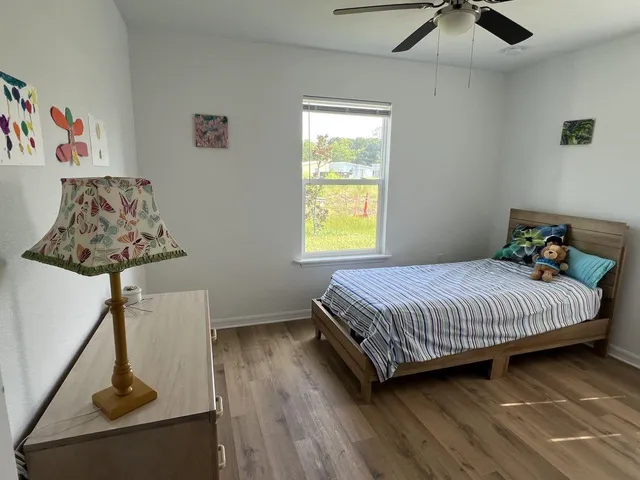 a bedroom with a bed and a window