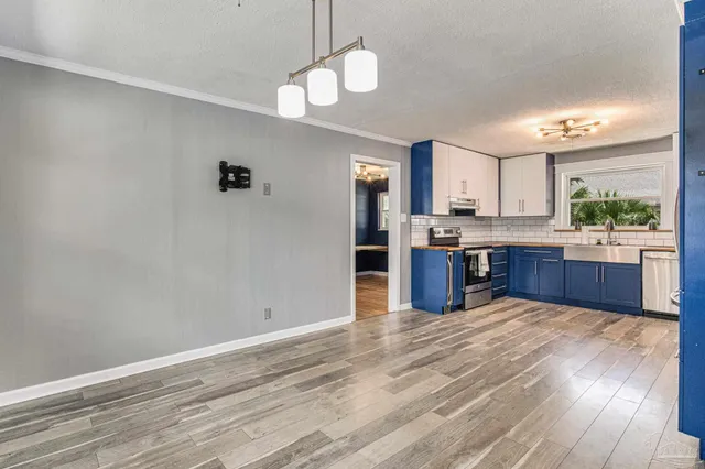 a kitchen with stainless steel appliances granite countertop a stove oven and a refrigerator