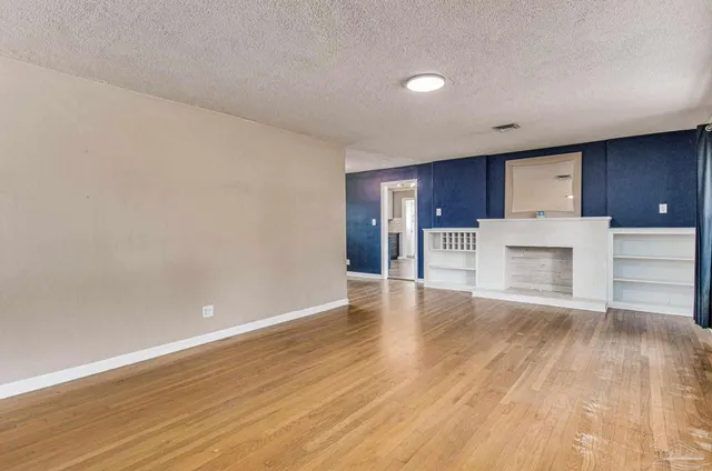 a view of a kitchen with a sink and a refrigerator