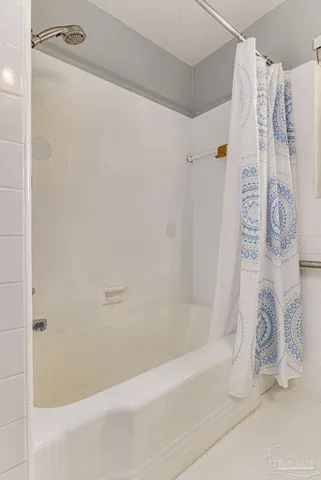 a bathroom with a bathtub and shower