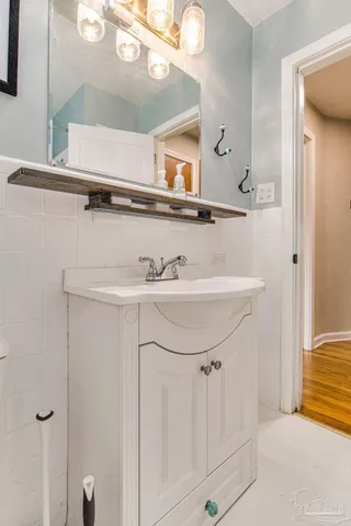 a bathroom with a sink a mirror and a bathtub