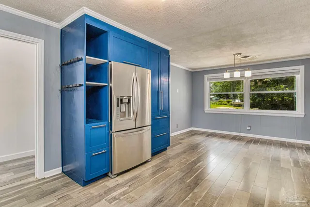 a kitchen with stainless steel appliances a refrigerator and a window