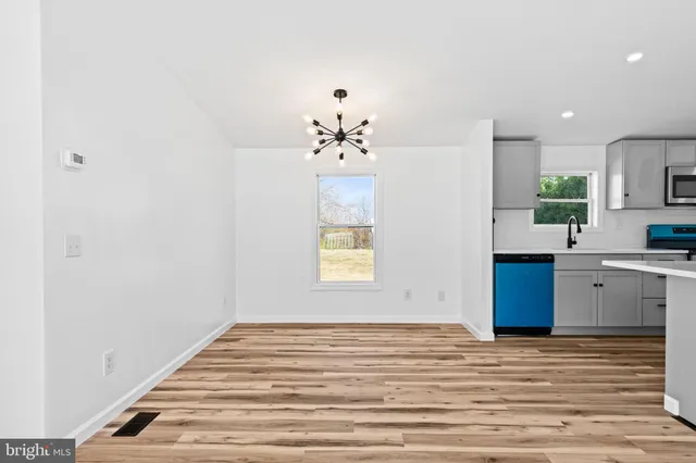 a view of a kitchen with a sink cabinets and wooden floor
